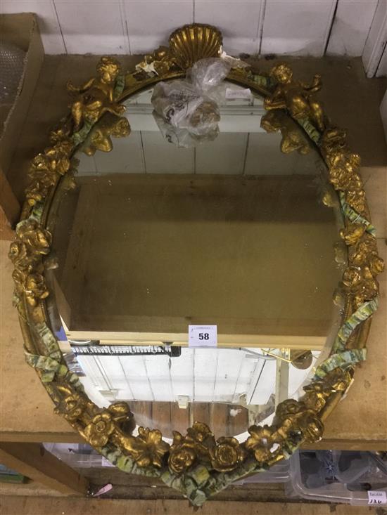 An oval gilt wall mirror